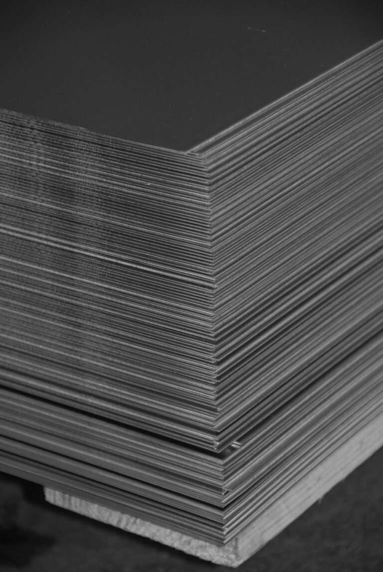 Aluminum sheet metal plates stacked on a palette, black and white